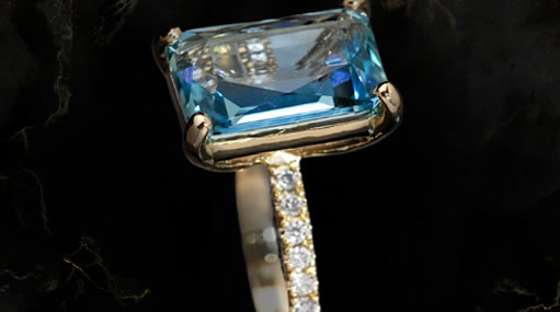 The Aqua Azure ring, an emerald-cut Santa Maria aquamarine in yellow gold with a diamond band