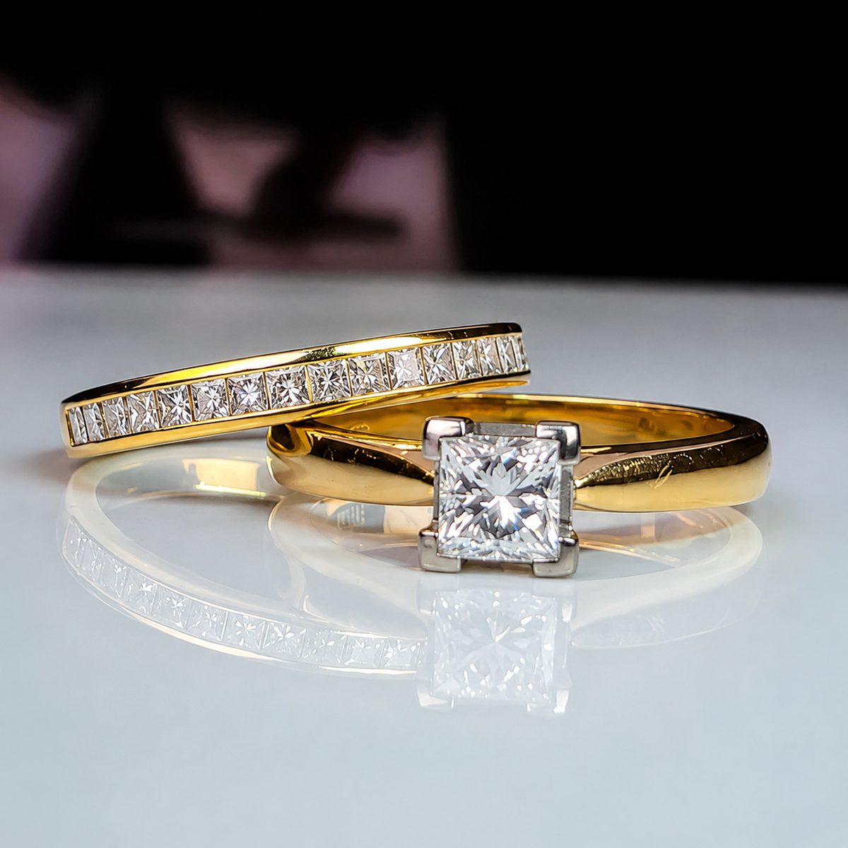 Princess-cut calibrated diamonds channel-set along a gold wedding band