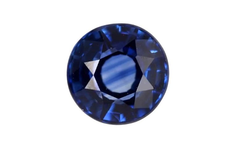 A dark commercial blue sapphire with dark patches and uneven colour