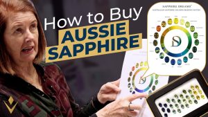 Ros from Sam's Group Australia with an Australian sapphire colour chart, from the video How to Buy Australian Sapphire