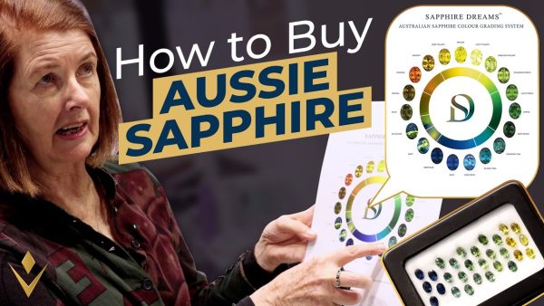 Ros from Sam's Group Australia with an Australian sapphire colour chart, from the video How to Buy Australian Sapphire
