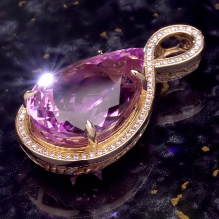 The Infinite Love Kunzite, a 100 carat purplish pink pear-shaped Afghan kunzite pendant with a diamond infinity loop and over 300 diamonds
