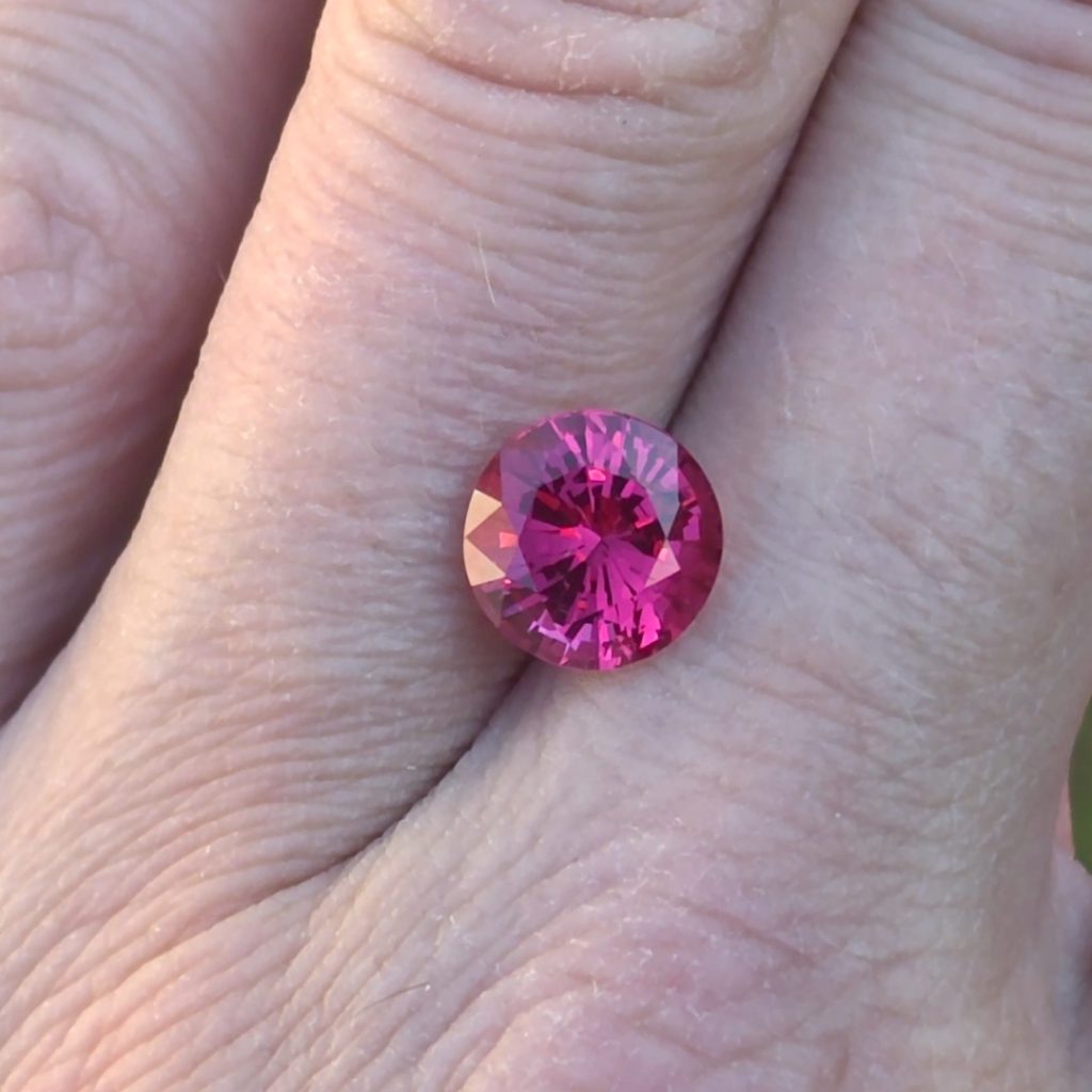 3.58ct Mogok spinel resting on a hand to show its size