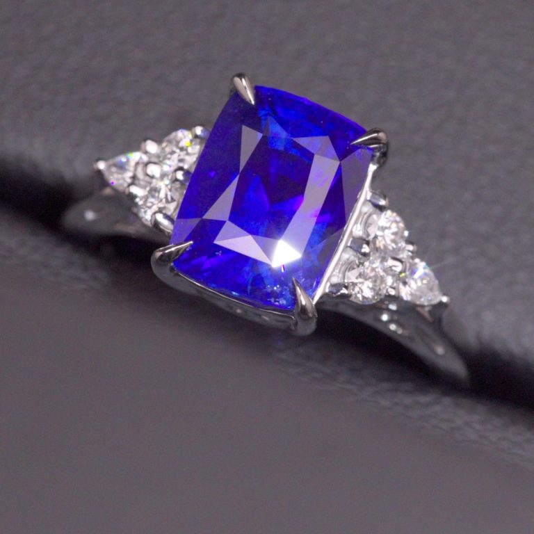 The Lewis Engagement Ring, a 5.6 carat vivid royal blue Ceylon sapphire with a trio of diamonds on each shoulder in 18ct white gold