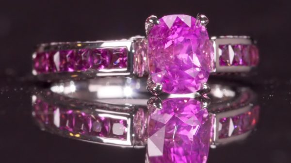 Princess Peach, a 2.12 carat unheated vivid purplish pink Ceylon sapphire ring with princess-cut and round amethysts in 18ct white gold