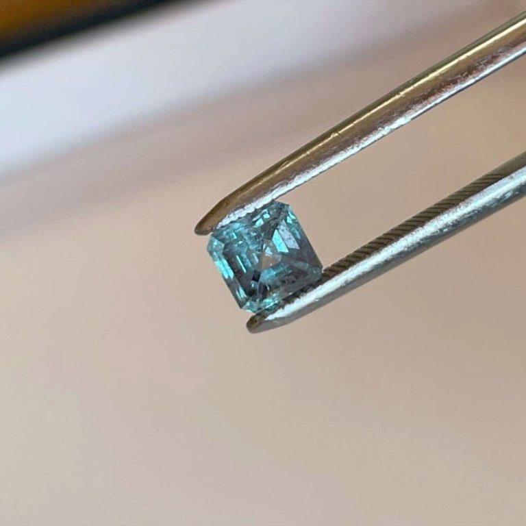 0.94ct Russian alexandrite in gem tweezers, green in daylight