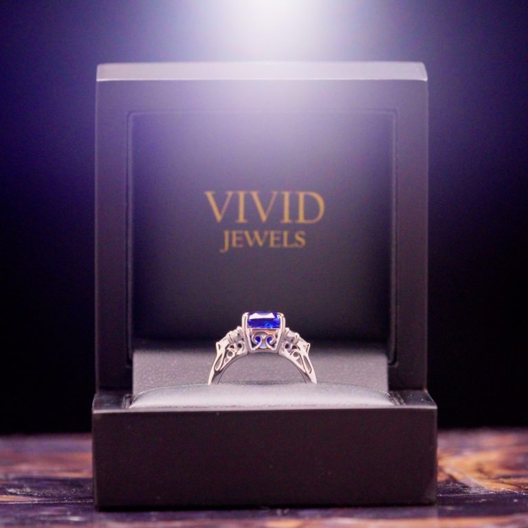 A royal blue sapphire engagement ring presented in a Vivid Jewels ring box